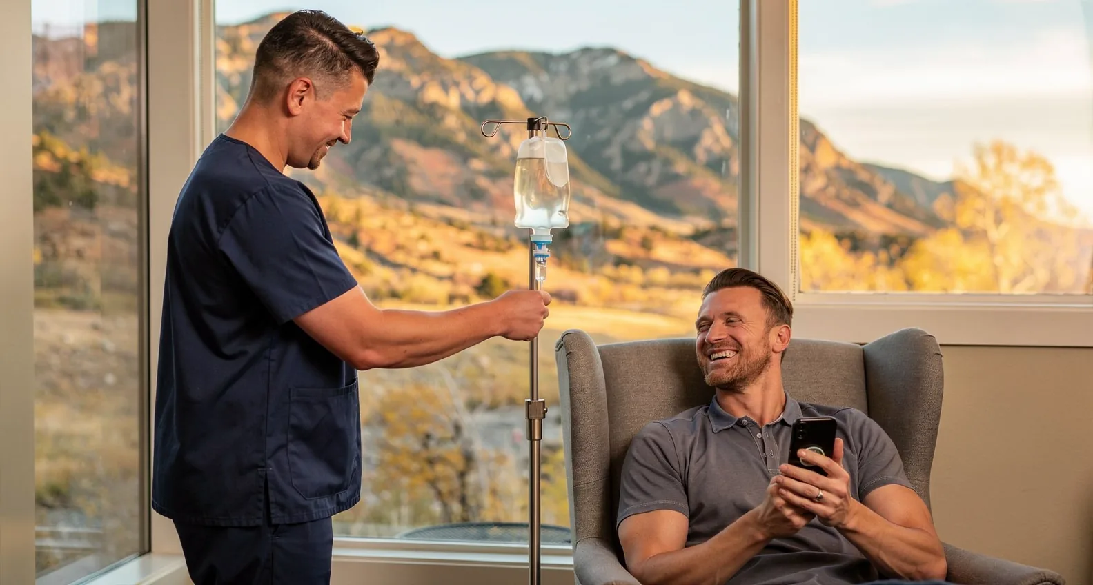 A nurse hanging an IV bag on a stand beside a client seated in a sunlit living room